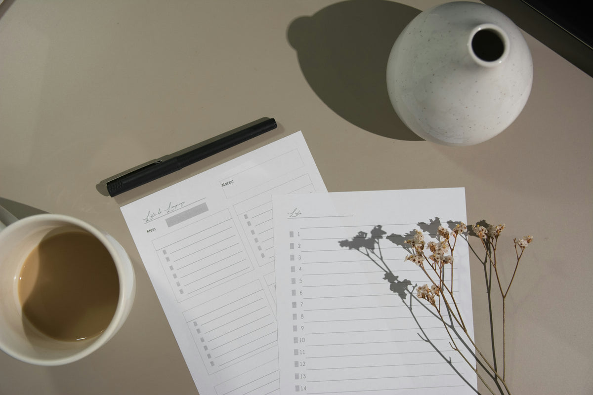 Printable planner pages next to a cup of coffee and dried flowers